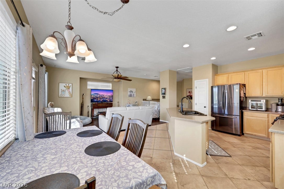 An open floor plan seamlessly connects the kitchen, dining space, and living area.