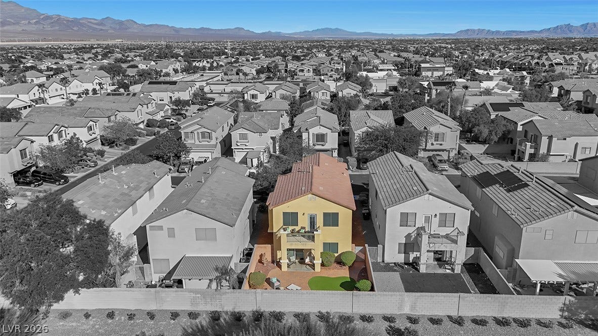 Distant mountain ranges form a scenic backdrop for this multi-level home and surrounding neighborhood.