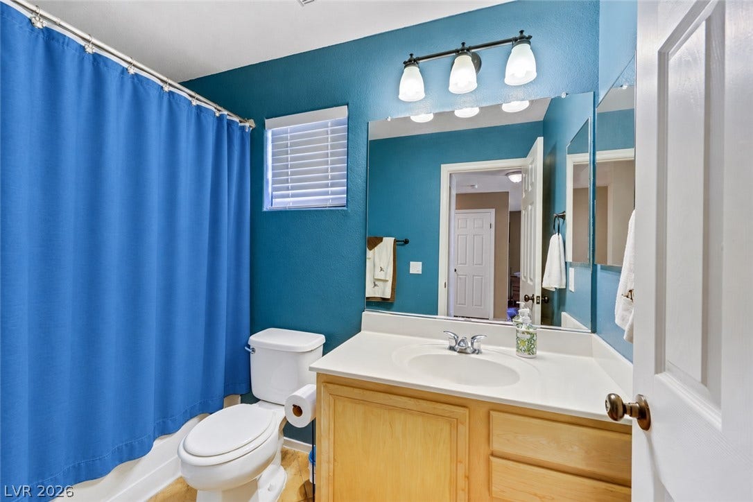 Full bath located on first story next to bedroom and near den. (AI used to remove items from space).