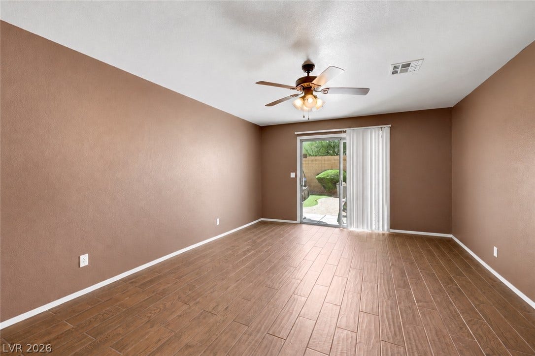 Den looking toward backyard. (AI used to remove contents of room)