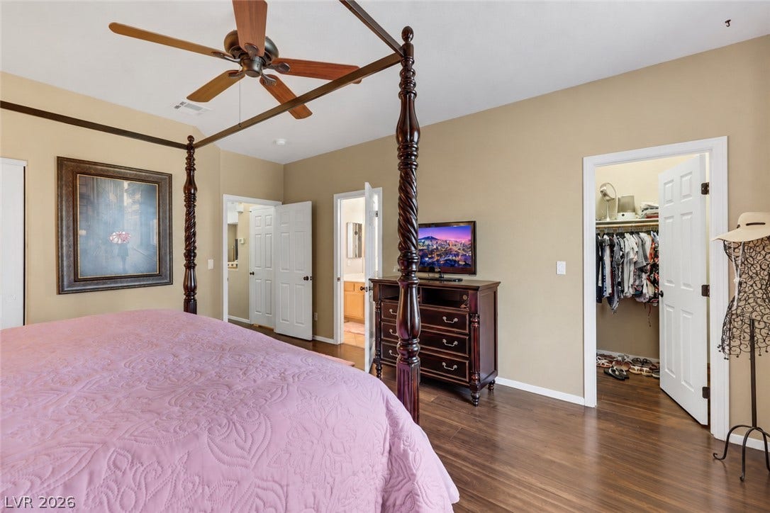 Primary suite looking to walk in closet (AI used to remove items from space).