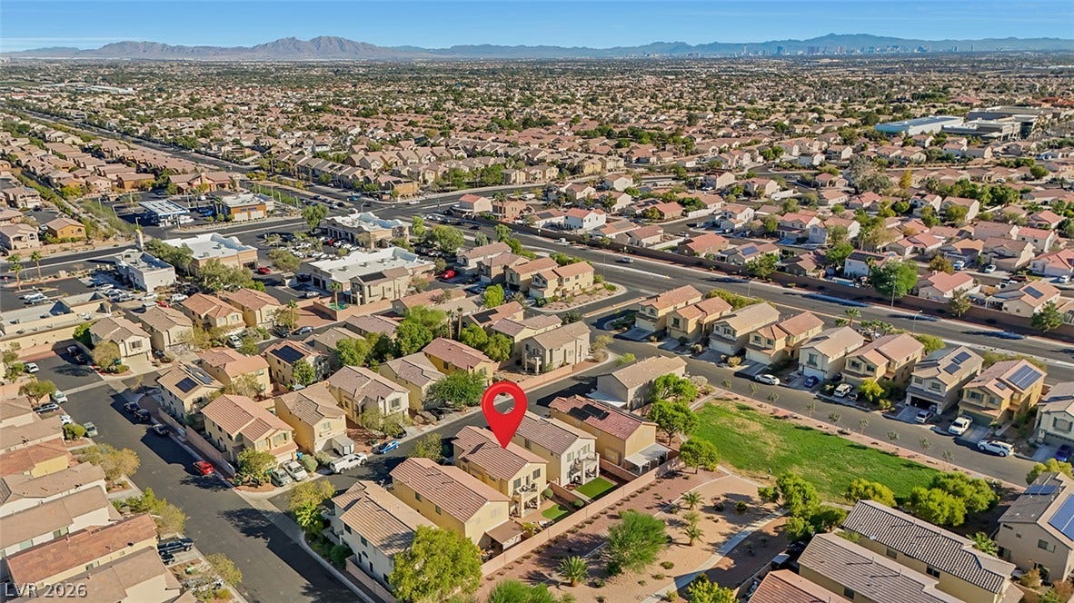 An aerial perspective showcases the home nestled within a tranquil desert neighborhood.