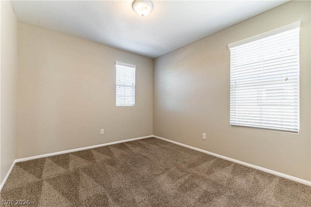 891 Harbor Avenue, Henderson, NV 89002 Plush carpeting and multiple windows equipped with blinds define this versatile secondary bedroom space.