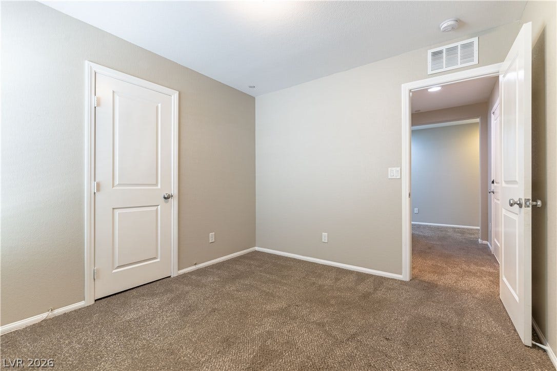 891 Harbor Avenue, Henderson, NV 89002 Plush wall-to-wall carpeting and clean baseboards define this versatile secondary bedroom space.