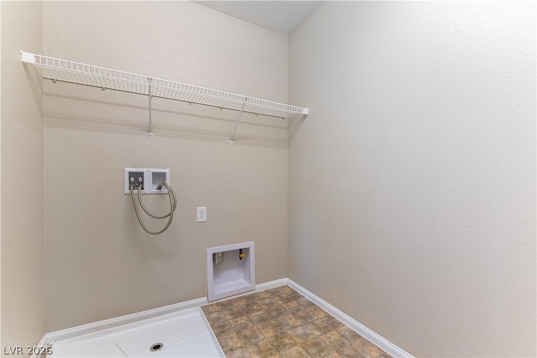 891 Harbor Avenue, Henderson, NV 89002 A dedicated utility space features overhead wire shelving and durable tiled flooring.