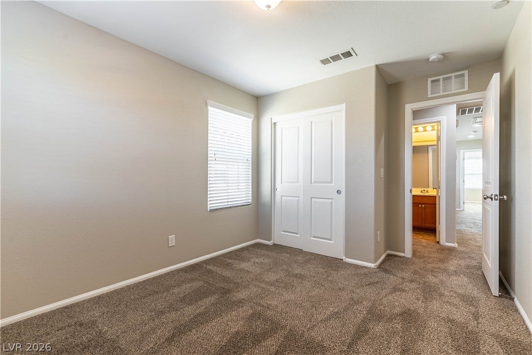891 Harbor Avenue, Henderson, NV 89002 Soft carpeting underfoot anchors this quiet space featuring a tall window and adjacent closet.