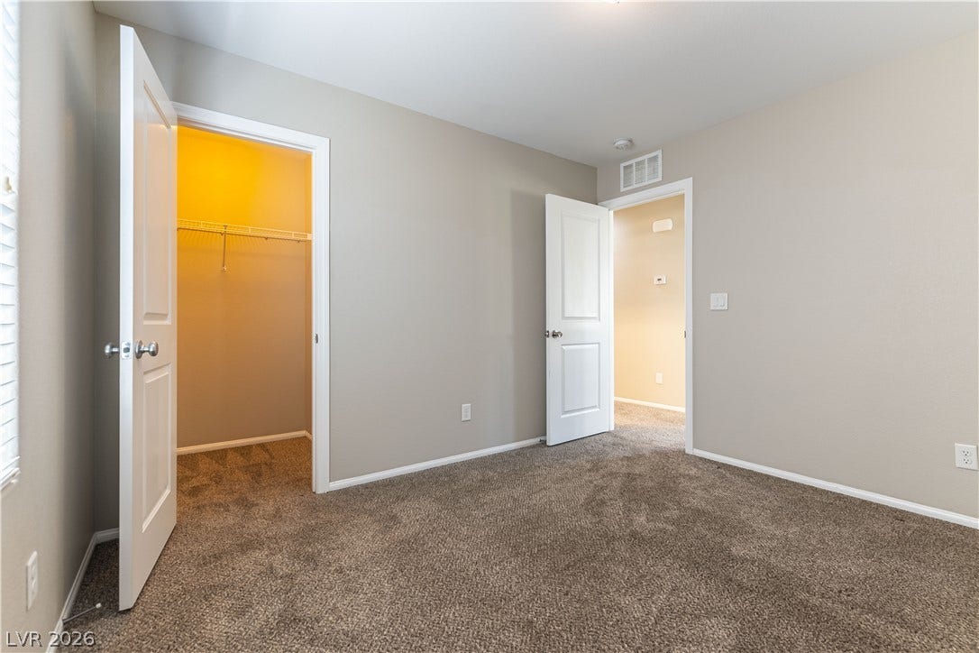 891 Harbor Avenue, Henderson, NV 89002 Plush wall-to-wall carpeting and neutral walls define this secondary bedroom with direct closet access.