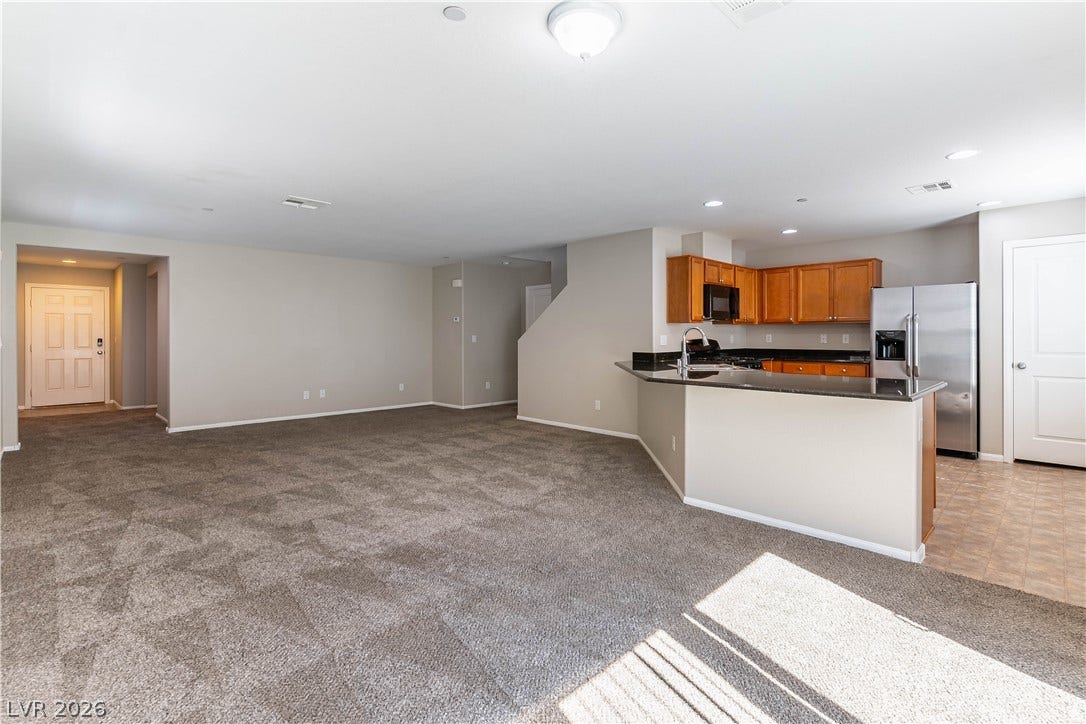 891 Harbor Avenue, Henderson, NV 89002 An open floorplan seamlessly connects the carpeted living area to the kitchen.
