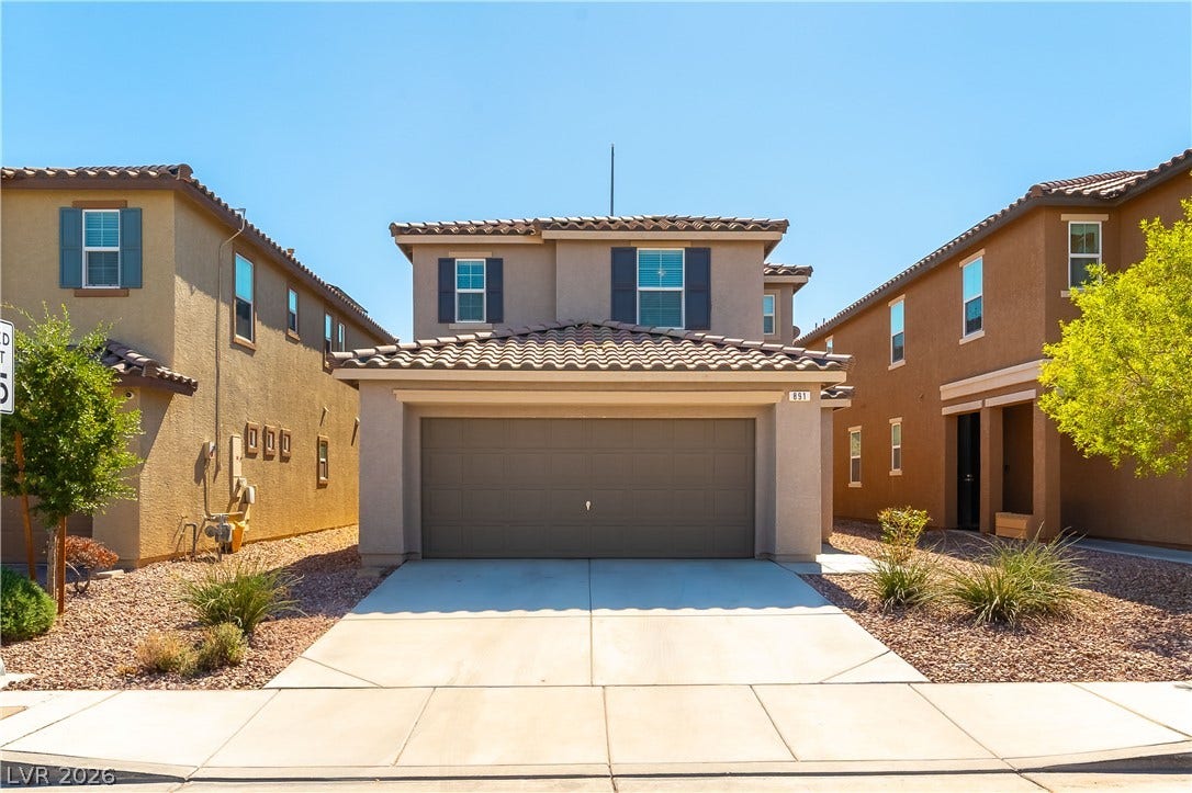 891 Harbor Avenue, Henderson, NV 89002 Spanish tile roofing and a concrete driveway accent this modern two-story home exterior.