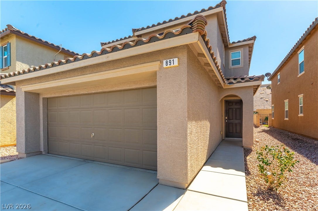 891 Harbor Avenue, Henderson, NV 89002 Spanish tile roofing and classic stucco siding define this modern multi-level exterior.