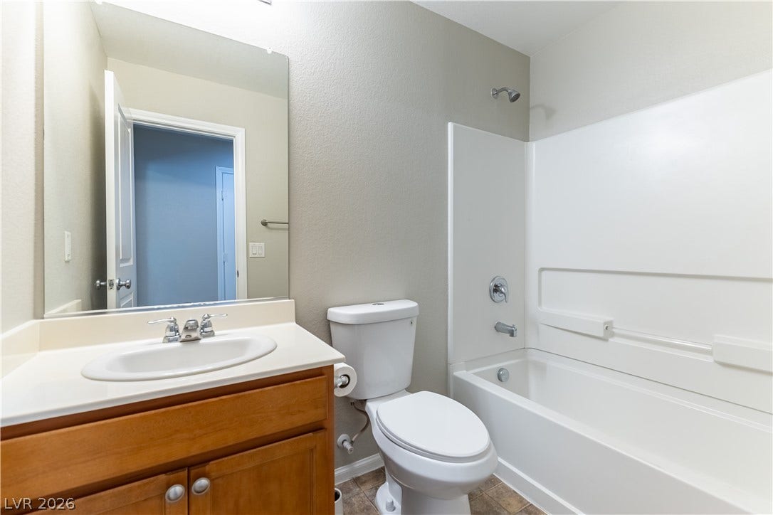 891 Harbor Avenue, Henderson, NV 89002 A classic vanity and tub-shower combination anchor this functional secondary bathroom.