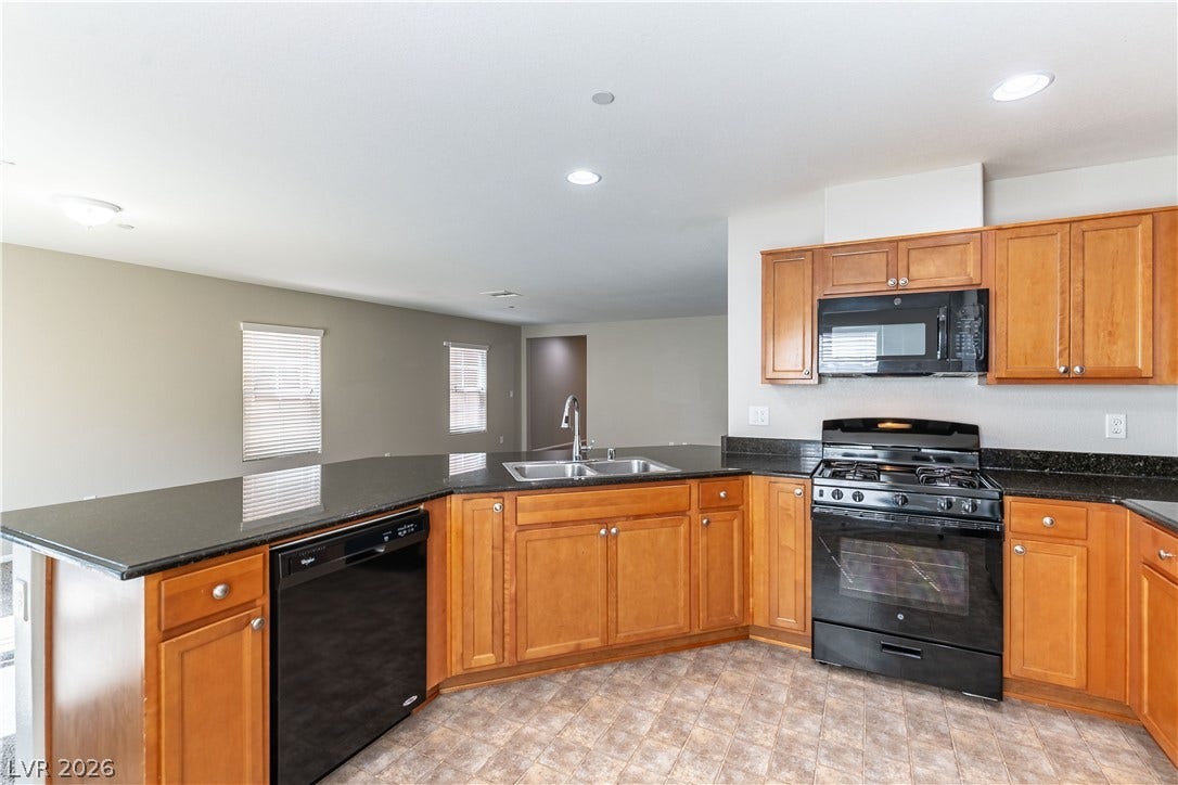 891 Harbor Avenue, Henderson, NV 89002 Polished granite countertops complement warm wood cabinetry in this open kitchen layout.