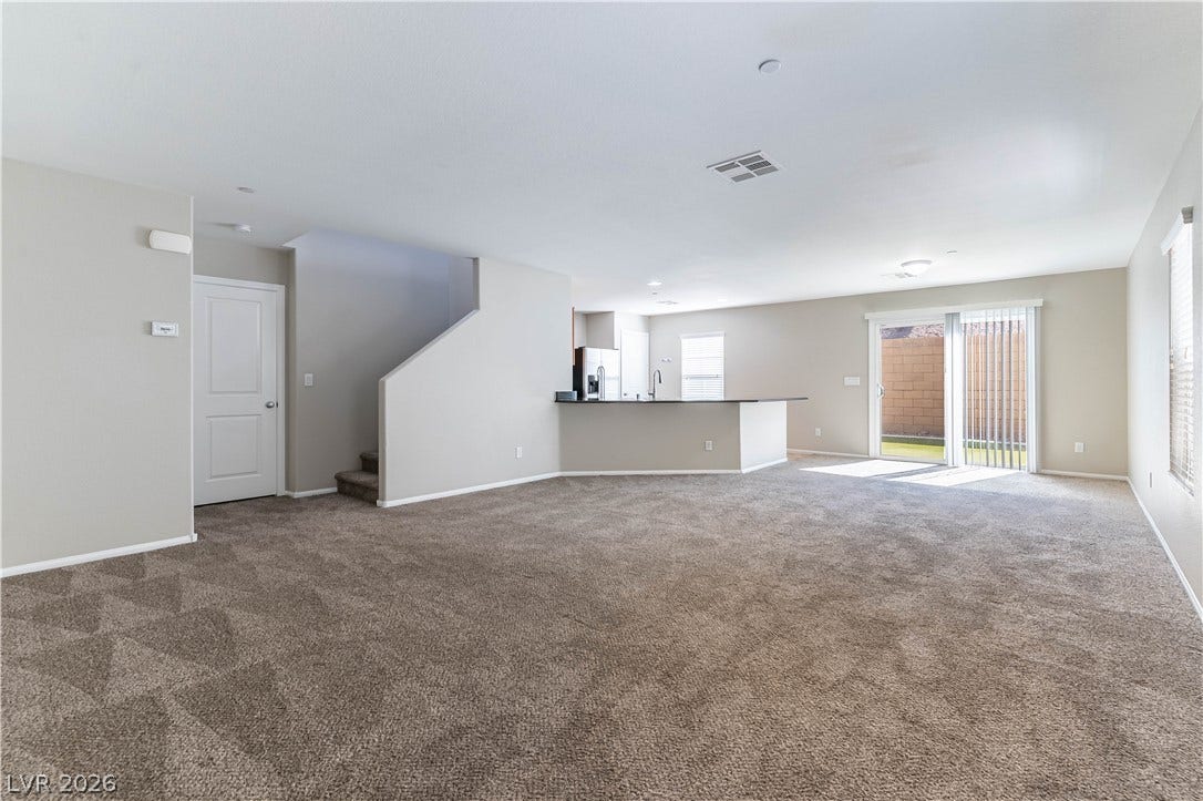 891 Harbor Avenue, Henderson, NV 89002 An open layout connects the carpeted living space directly to the kitchen.