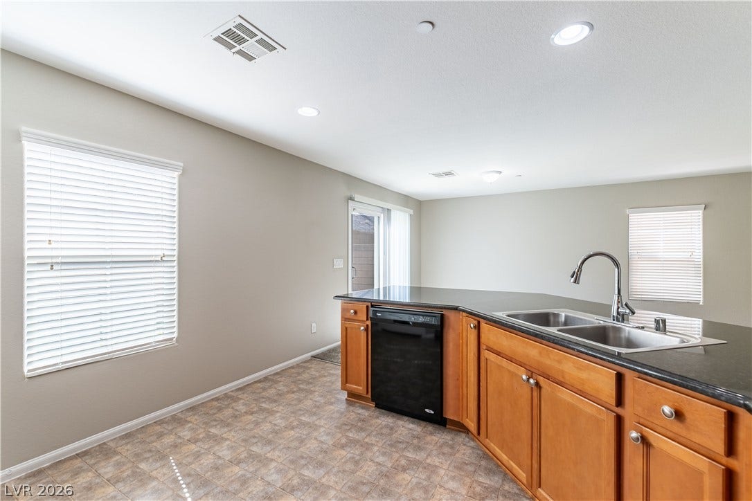 891 Harbor Avenue, Henderson, NV 89002 Polished countertops and warm wood cabinetry define this inviting kitchen area.