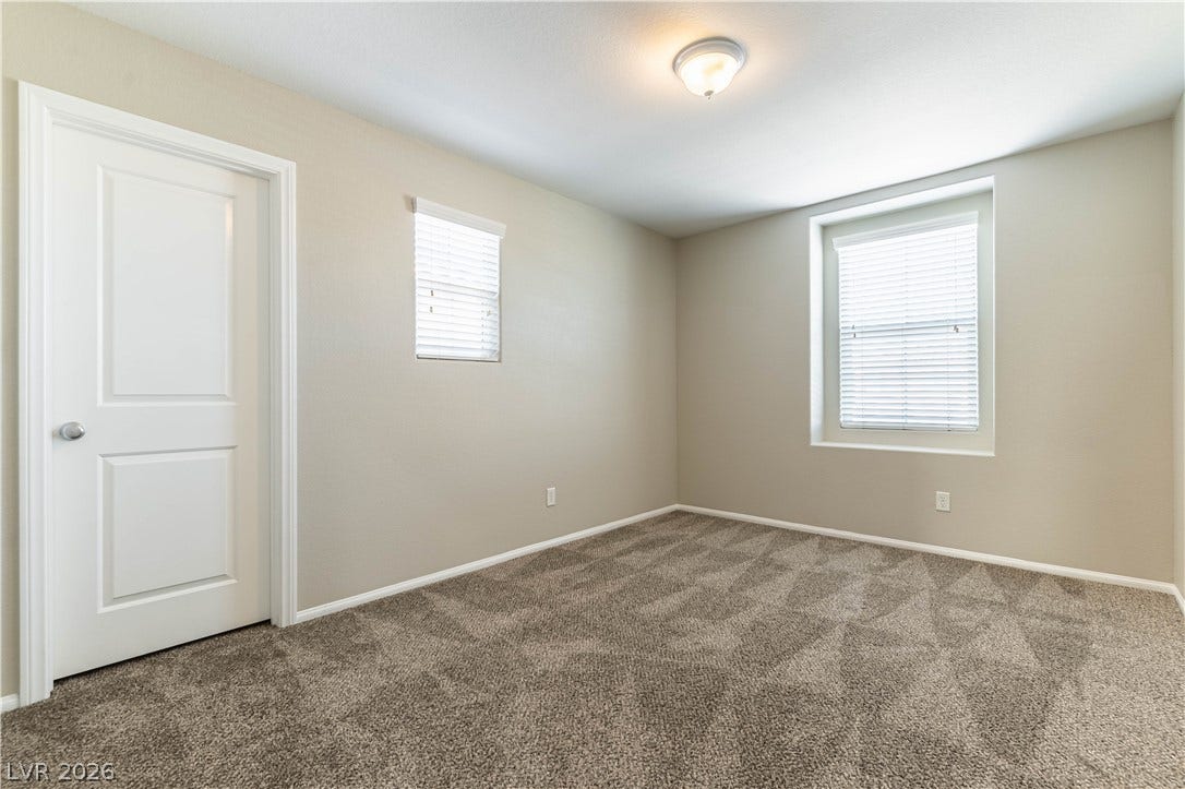 891 Harbor Avenue, Henderson, NV 89002 Plush carpeting and neutral-toned walls create a peaceful, inviting atmosphere in this versatile bedroom.