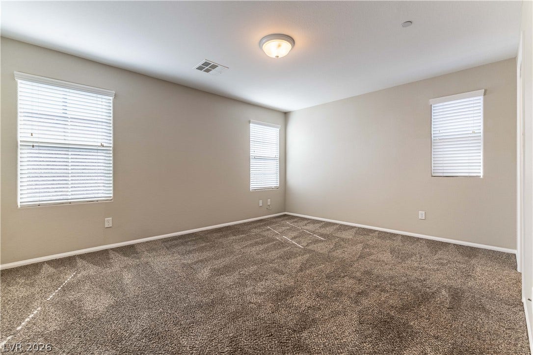 891 Harbor Avenue, Henderson, NV 89002 Plush carpeting and multiple windows anchor this versatile bedroom space.