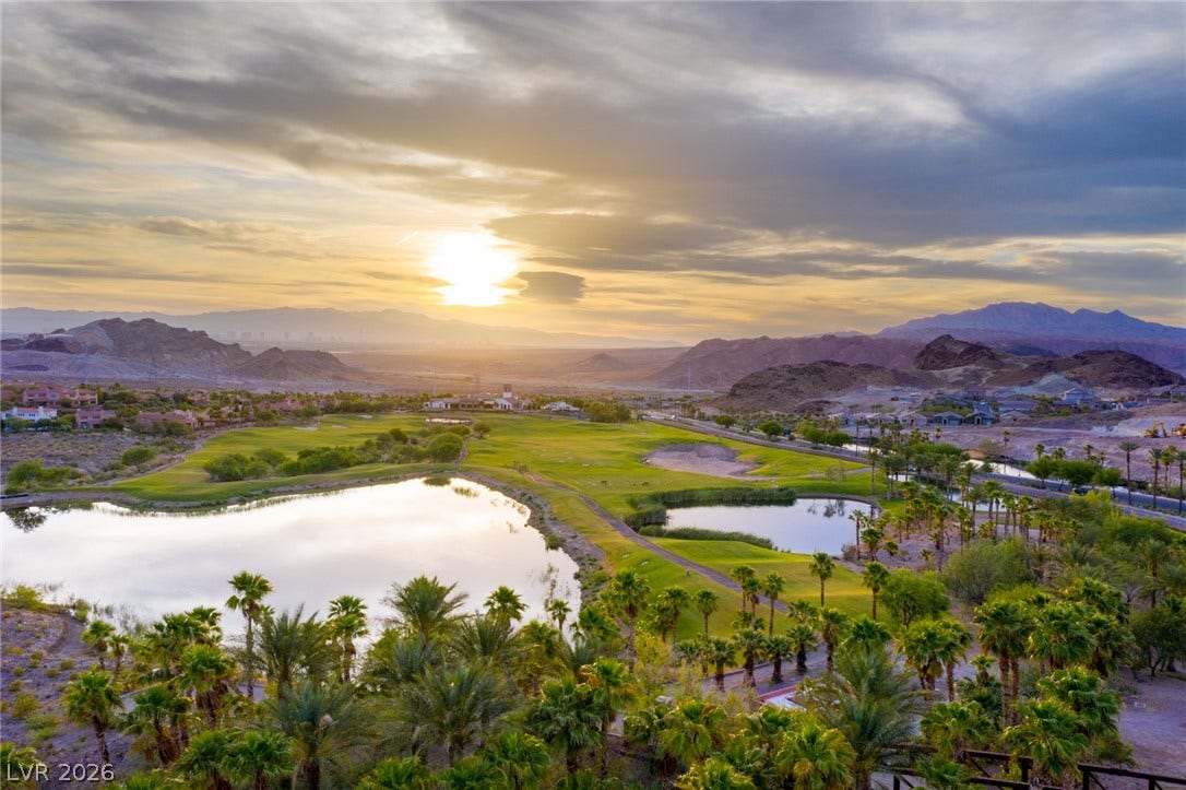 18 Heron Harbour Drive, Henderson, NV 89011 Dramatic mountain ranges and sparkling water create a scenic backdrop over the green fairway.