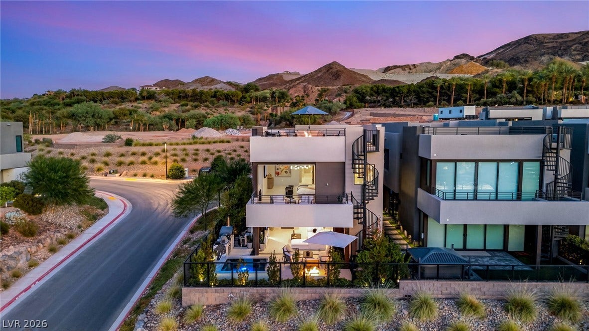 18 Heron Harbour Drive, Henderson, NV 89011 Multi-level modern architecture sits nestled against a dramatic mountain backdrop.