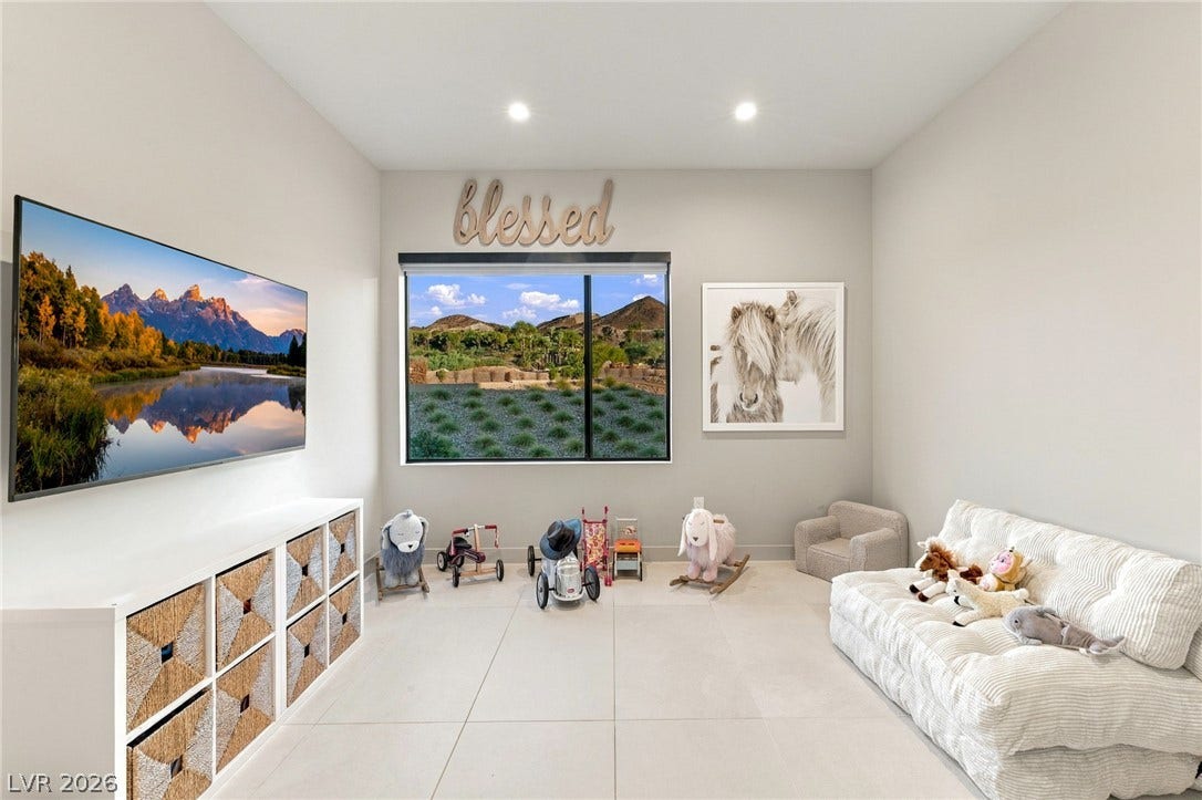 18 Heron Harbour Drive, Henderson, NV 89011 A wide window frames picturesque mountain views in this versatile modern space with tiled flooring.