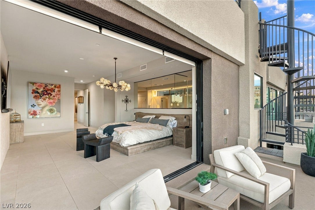 18 Heron Harbour Drive, Henderson, NV 89011 Massive sliding glass doors merge a generous bedroom suite with the outdoor terrace.