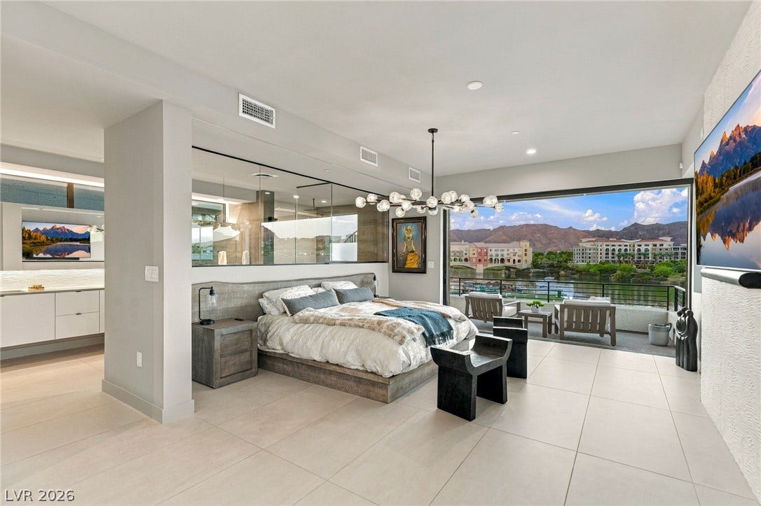 18 Heron Harbour Drive, Henderson, NV 89011 Retractable glass doors seamlessly connect this bedroom to a scenic private balcony.