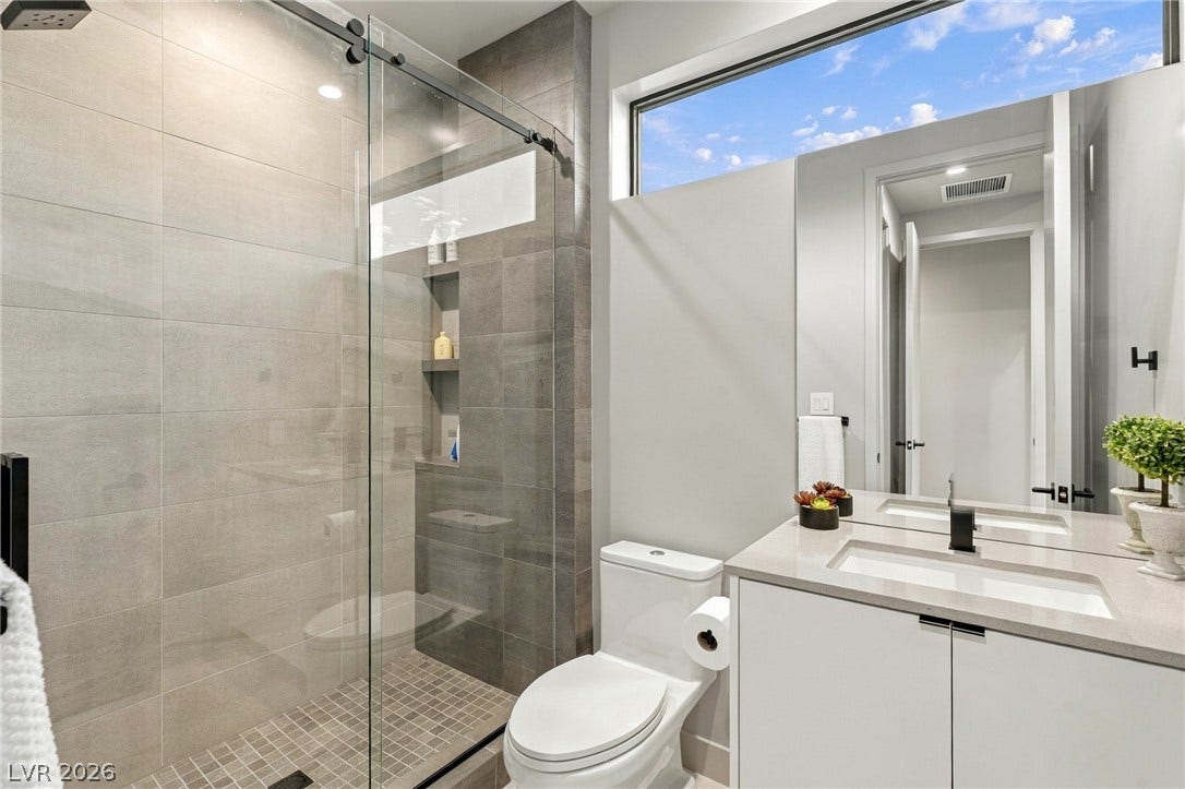 18 Heron Harbour Drive, Henderson, NV 89011 High clerestory windows bring natural light into this modern tiled bathroom.