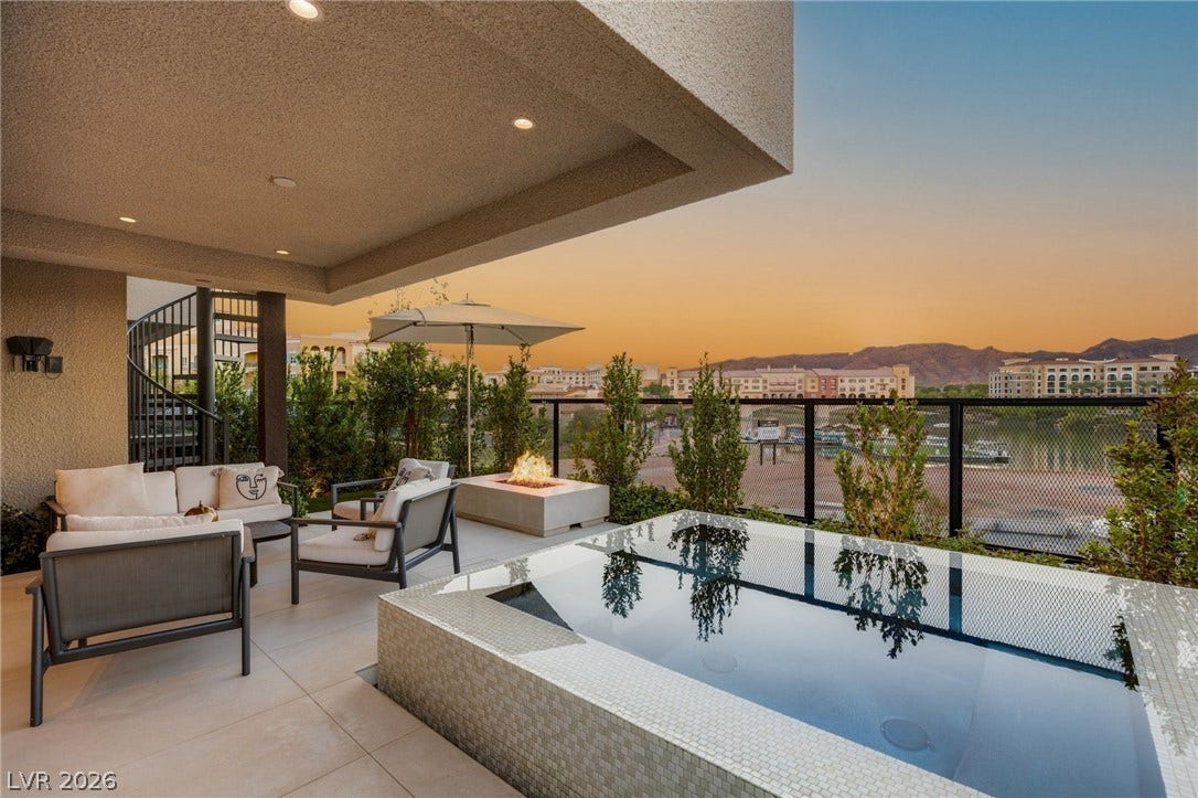 18 Heron Harbour Drive, Henderson, NV 89011 An elevated patio features tiled flooring, a built-in spa, and scenic mountain views.