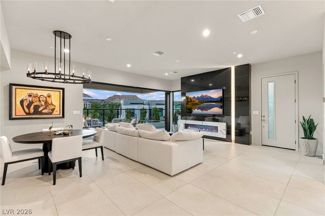 18 Heron Harbour Drive, Henderson, NV 89011 Clean tile flooring and a sleek fireplace wall define this contemporary living space.