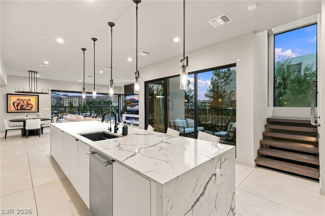 18 Heron Harbour Drive, Henderson, NV 89011 Clean lines and stone countertops anchor this modern open floorplan with sliding glass doors.