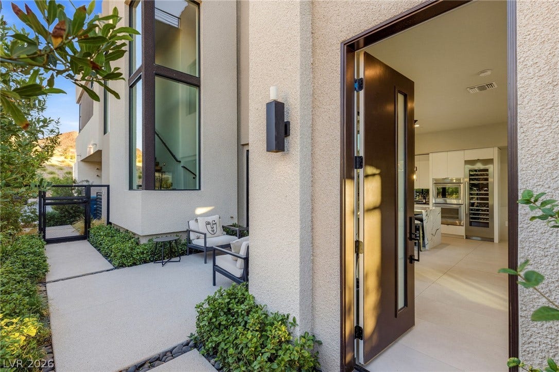 18 Heron Harbour Drive, Henderson, NV 89011 An inviting entryway leads past a courtyard into a bright interior with high ceilings.