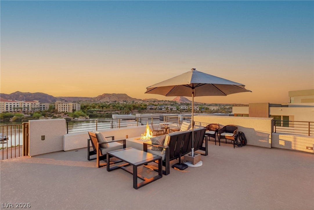 18 Heron Harbour Drive, Henderson, NV 89011 Panoramic mountain and water views elevate this spacious rooftop terrace with a built-in fire pit.