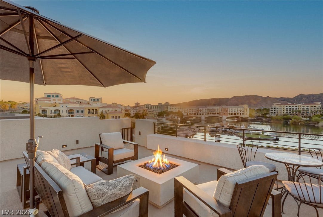 18 Heron Harbour Drive, Henderson, NV 89011 Sweeping water and mountain vistas frame this elevated terrace complete with a modern fire pit.