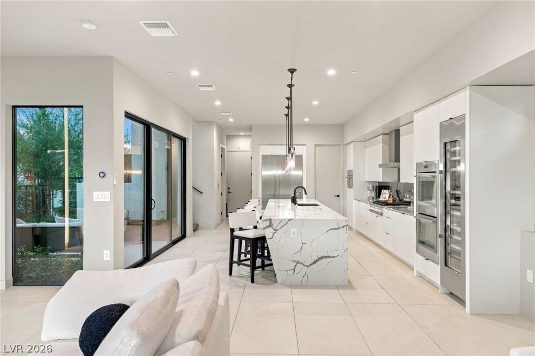 18 Heron Harbour Drive, Henderson, NV 89011 Sleek modern lines define this open culinary space featuring stone countertops and integrated appliances.