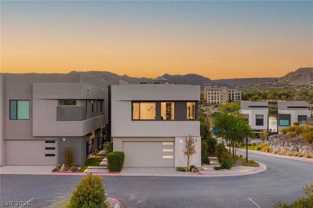 18 Heron Harbour Drive, Henderson, NV 89011 Striking contemporary architecture stands set against a dramatic desert mountain backdrop.