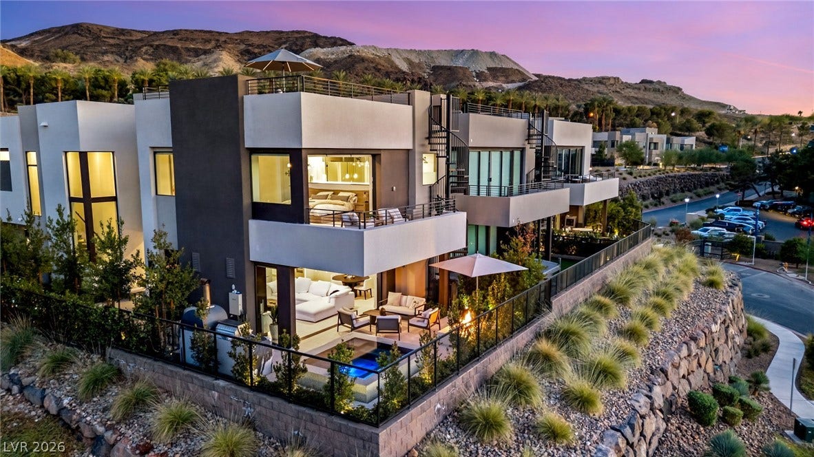 18 Heron Harbour Drive, Henderson, NV 89011 Striking contemporary architecture integrates multi-level terraces overlooking a scenic desert mountain landscape.