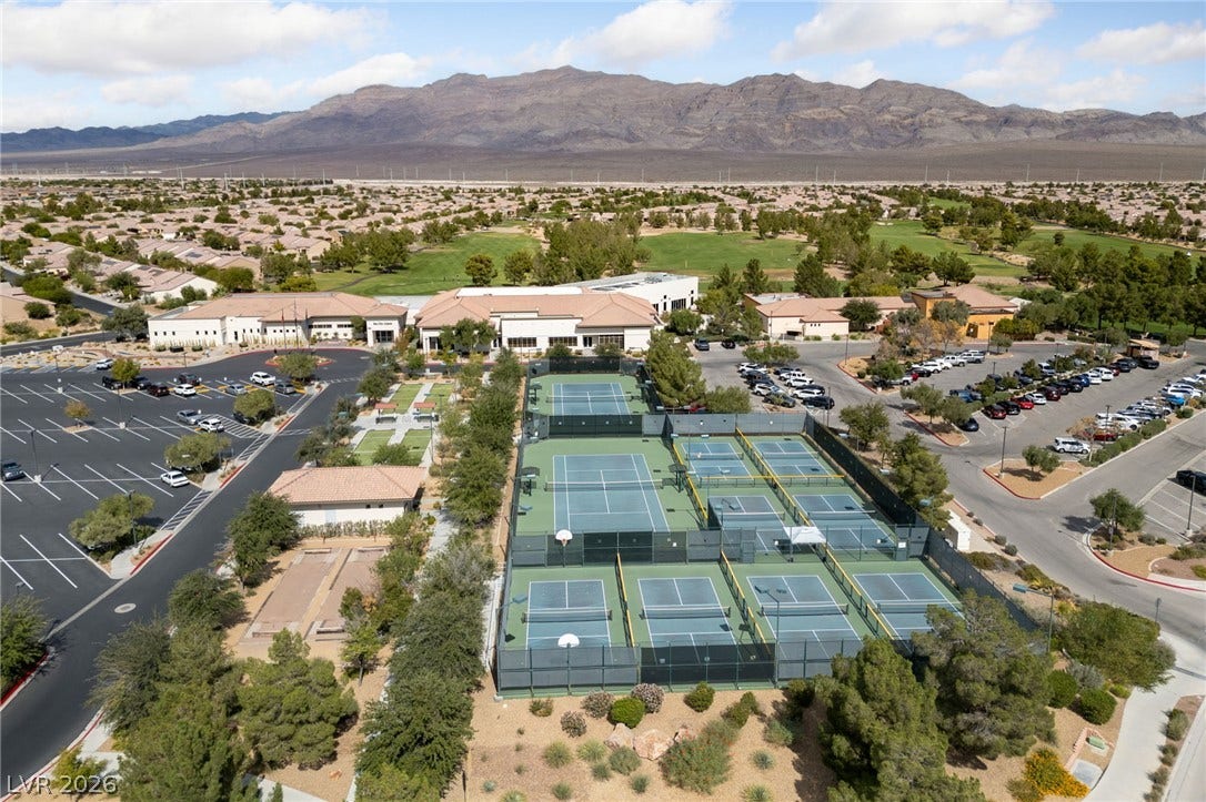 7340 Shelduck Street, North Las Vegas, NV 89084 Several athletic courts are situated near community buildings with a mountain range backdrop.