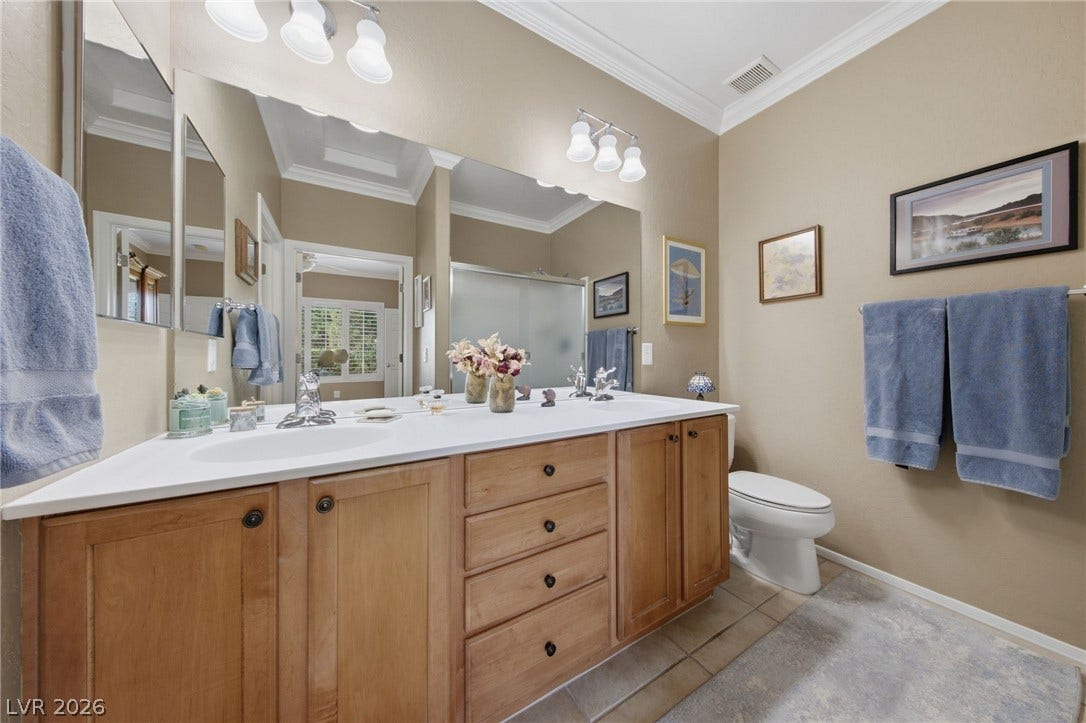 7340 Shelduck Street, North Las Vegas, NV 89084 Elegant crown molding complements warm wood cabinetry and neutral tile flooring.
