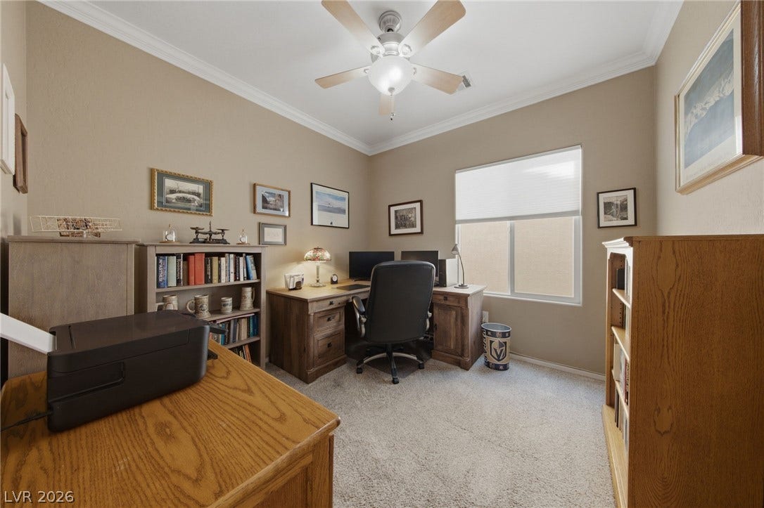 7340 Shelduck Street, North Las Vegas, NV 89084 Thick crown molding and soft neutral walls frame this quiet home office space.