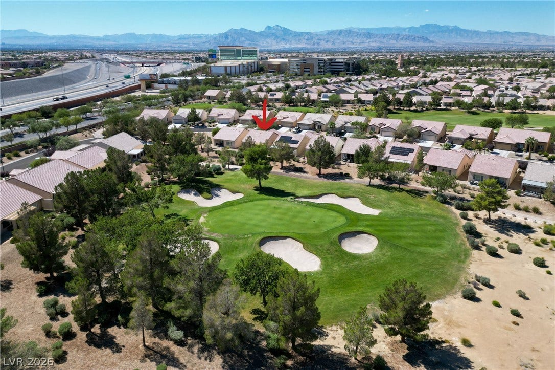 7340 Shelduck Street, North Las Vegas, NV 89084 Aerial view of home. Lush fairways and majestic mountain ridges frame this desert community setting.