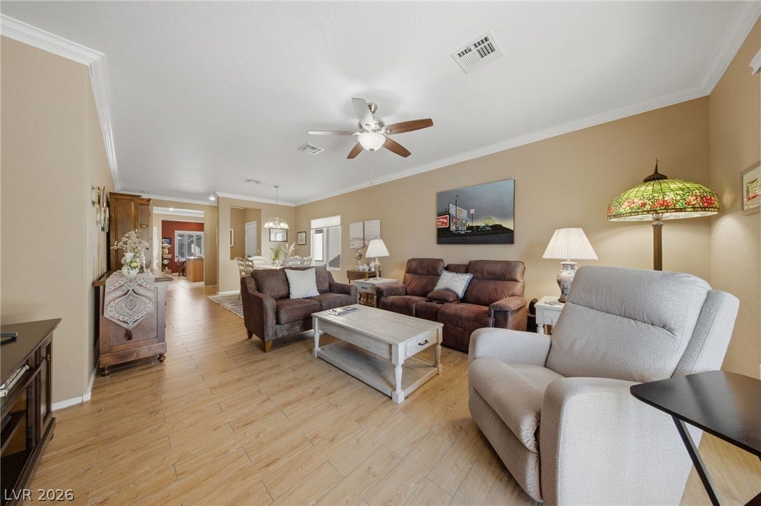 7340 Shelduck Street, North Las Vegas, NV 89084 Crown molding and wood-look flooring enhance this inviting open-concept living space.