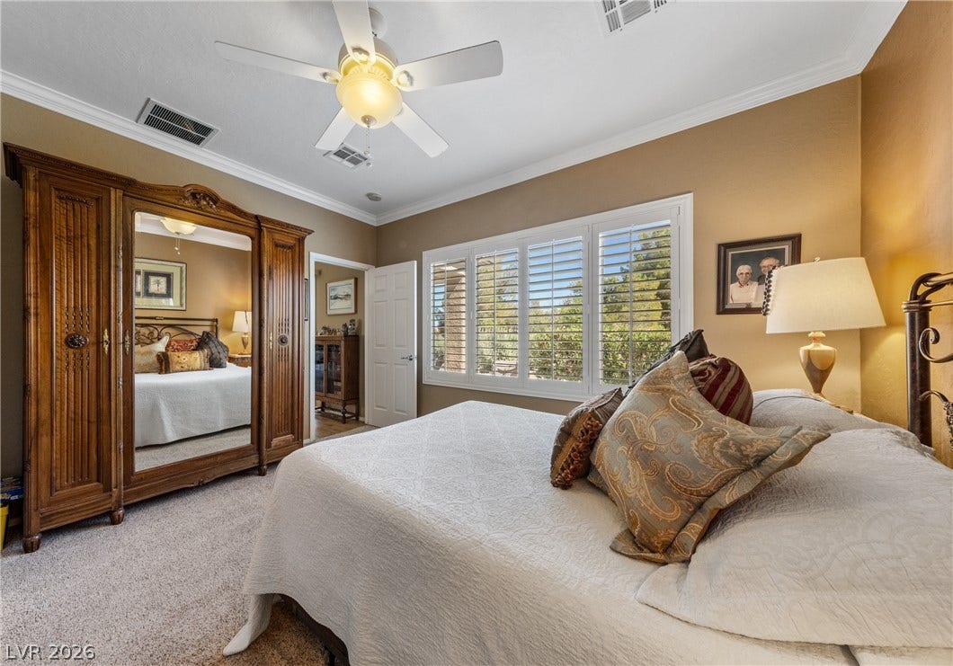 7340 Shelduck Street, North Las Vegas, NV 89084 Crown molding and plantation shutters enhance this comfortable bedroom space.