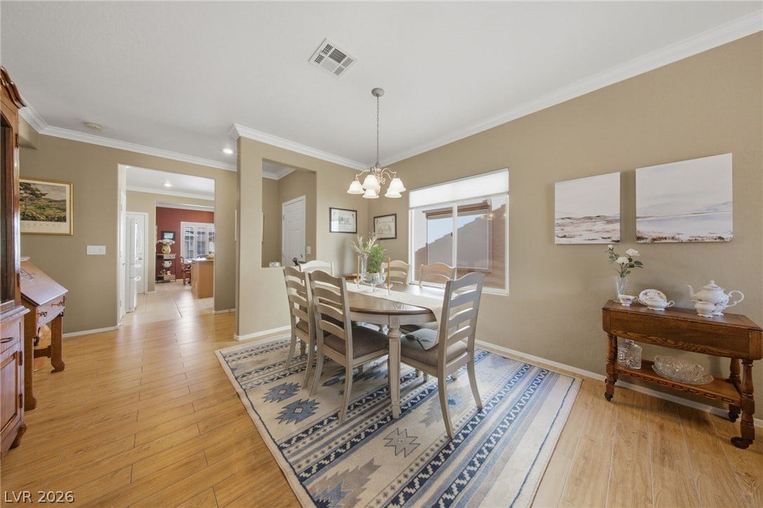 7340 Shelduck Street, North Las Vegas, NV 89084 Elegant crown molding and wood-look flooring define this welcoming formal dining space.
