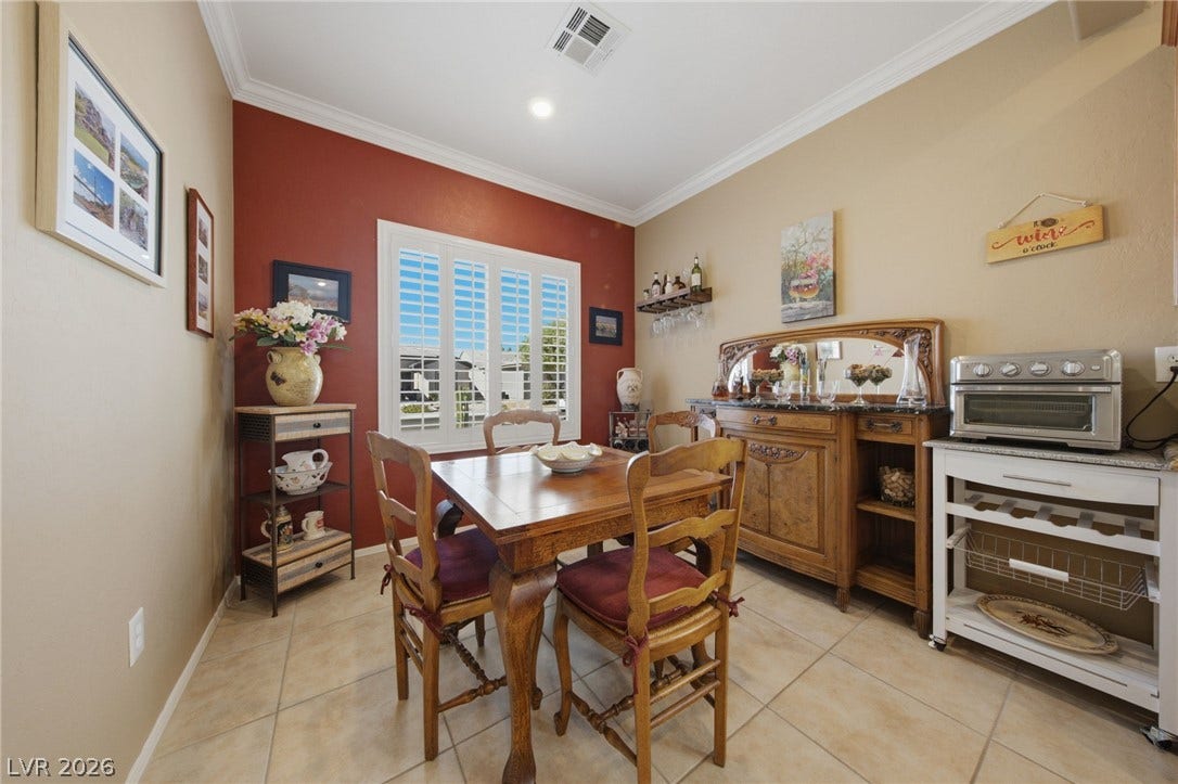 7340 Shelduck Street, North Las Vegas, NV 89084 Elegant crown molding complements tile flooring in this inviting dining area.
