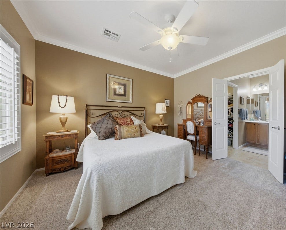 7340 Shelduck Street, North Las Vegas, NV 89084 Plush carpeting and elegant crown molding define this spacious owner suite with an attached bath.