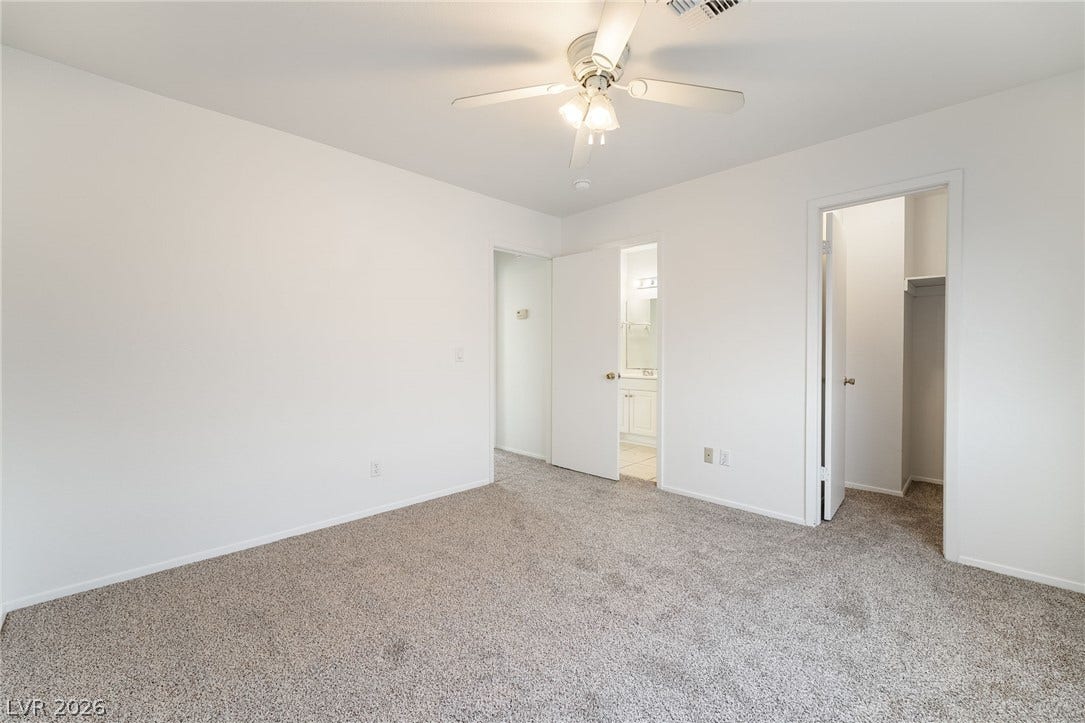 535 Sellers Place, Henderson, NV 89011 An inviting bedroom features soft neutral carpeting and direct access to an en suite bath.