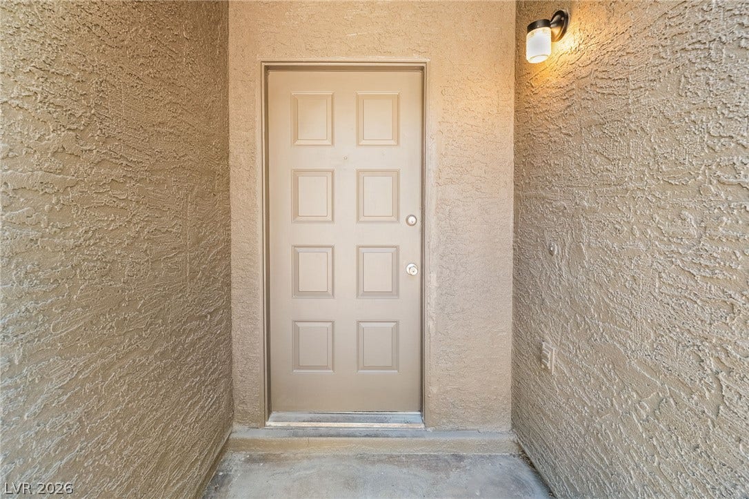 535 Sellers Place, Henderson, NV 89011 Textured stucco walls flank a recessed concrete entryway leading to the paneled entry door.
