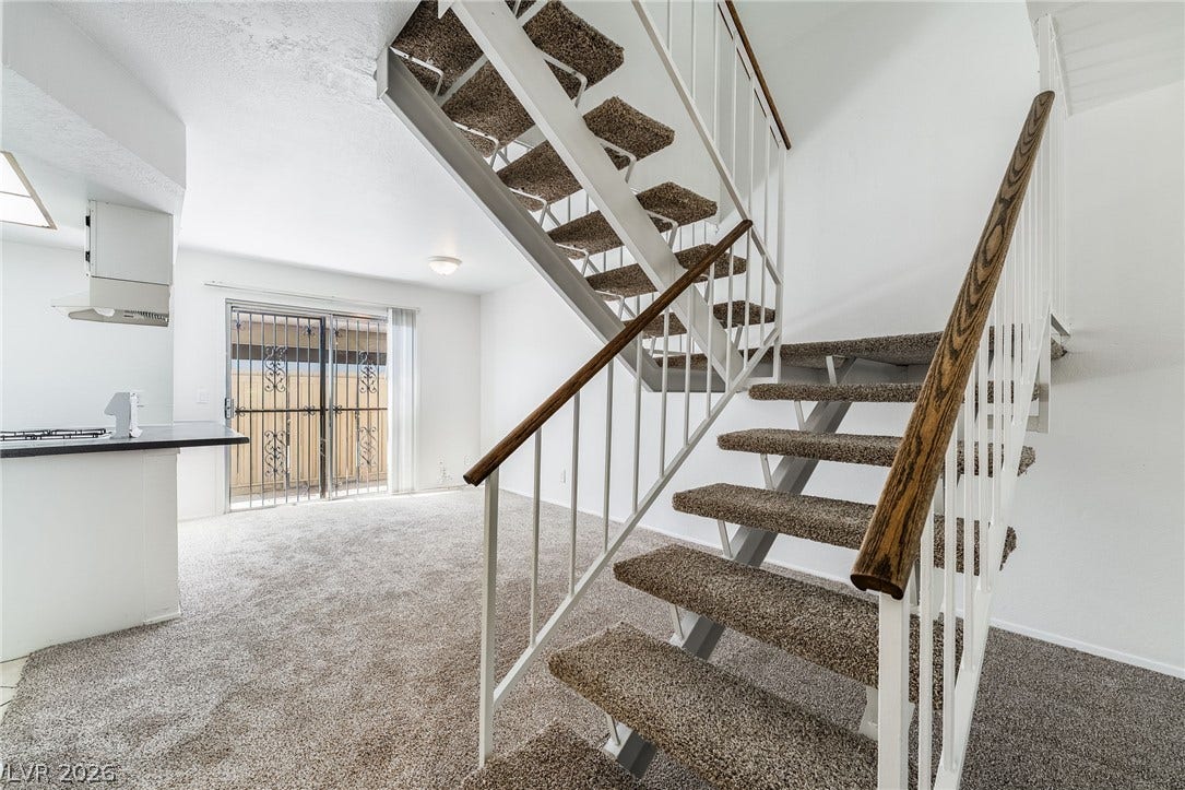 535 Sellers Place, Henderson, NV 89011 An open stairway with plush carpeting connects the main level to the upper floor.