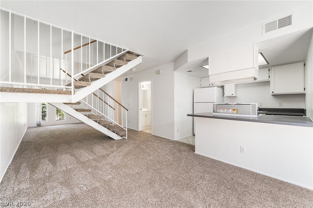 535 Sellers Place, Henderson, NV 89011 An open multi-level layout unites the carpeted living space with a functional kitchen area.