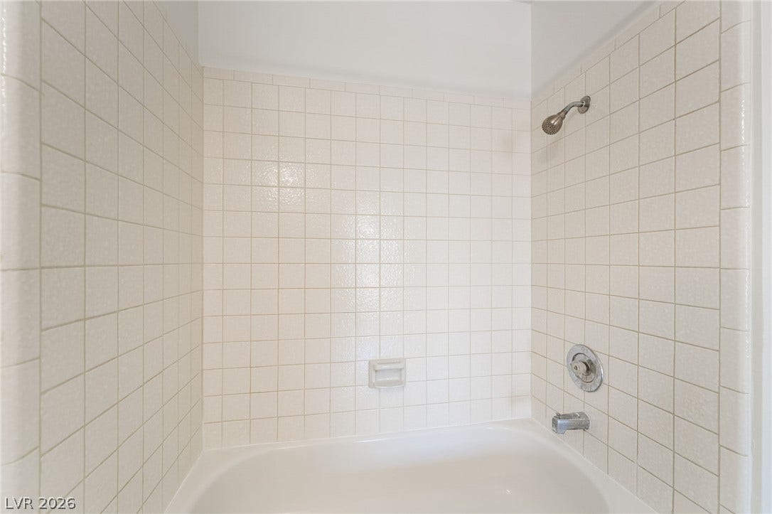 535 Sellers Place, Henderson, NV 89011 Classic square tiling surrounds a clean bathtub and shower combination.