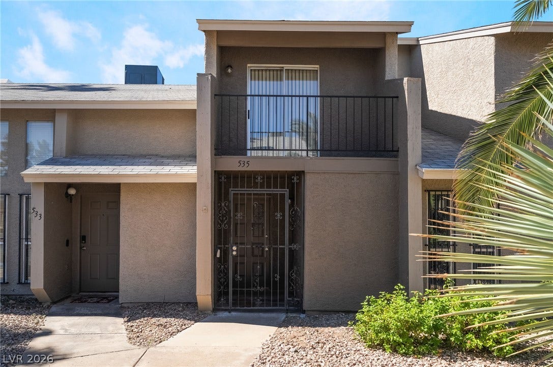 535 Sellers Place, Henderson, NV 89011 Stucco exterior elements highlight the private gated entrance and upper-level balcony of this townhouse.
